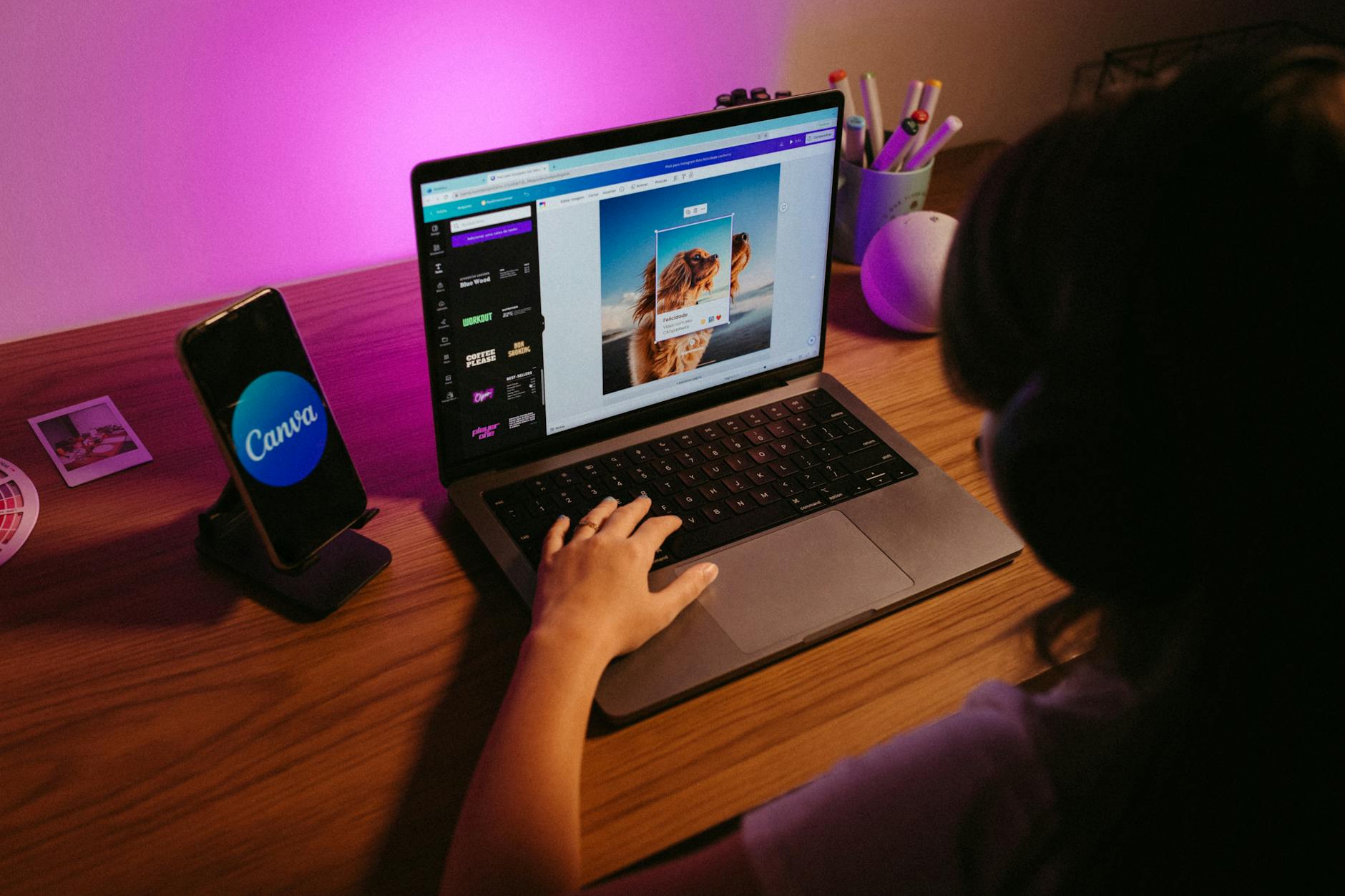 girl using canva website on laptop